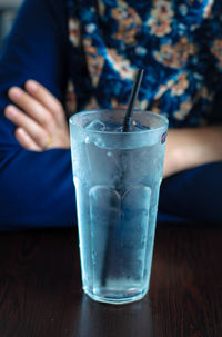 Close-up of woman with drink on table