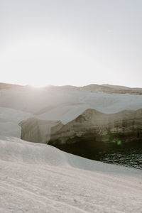 Scenic view of snowcapped mountains against clear sky