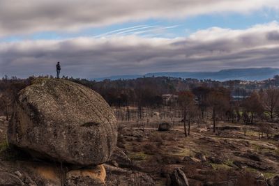 Panoramic view of rocks on field against sky