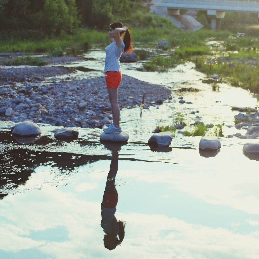 full length, lifestyles, leisure activity, childhood, casual clothing, boys, standing, day, rear view, balance, outdoors, sport, elementary age, holding, men, water, mid-air, nature