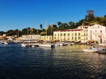 Boats in river with buildings in background