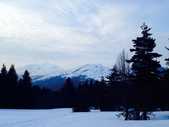 Scenic view of snow covered mountains against sky