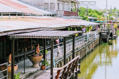 People in canal by buildings in city