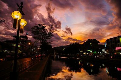 City street against cloudy sky at dusk