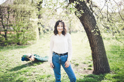 Happy young woman in a white blouse in a park. springtime