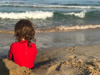 Rear view of girl on beach