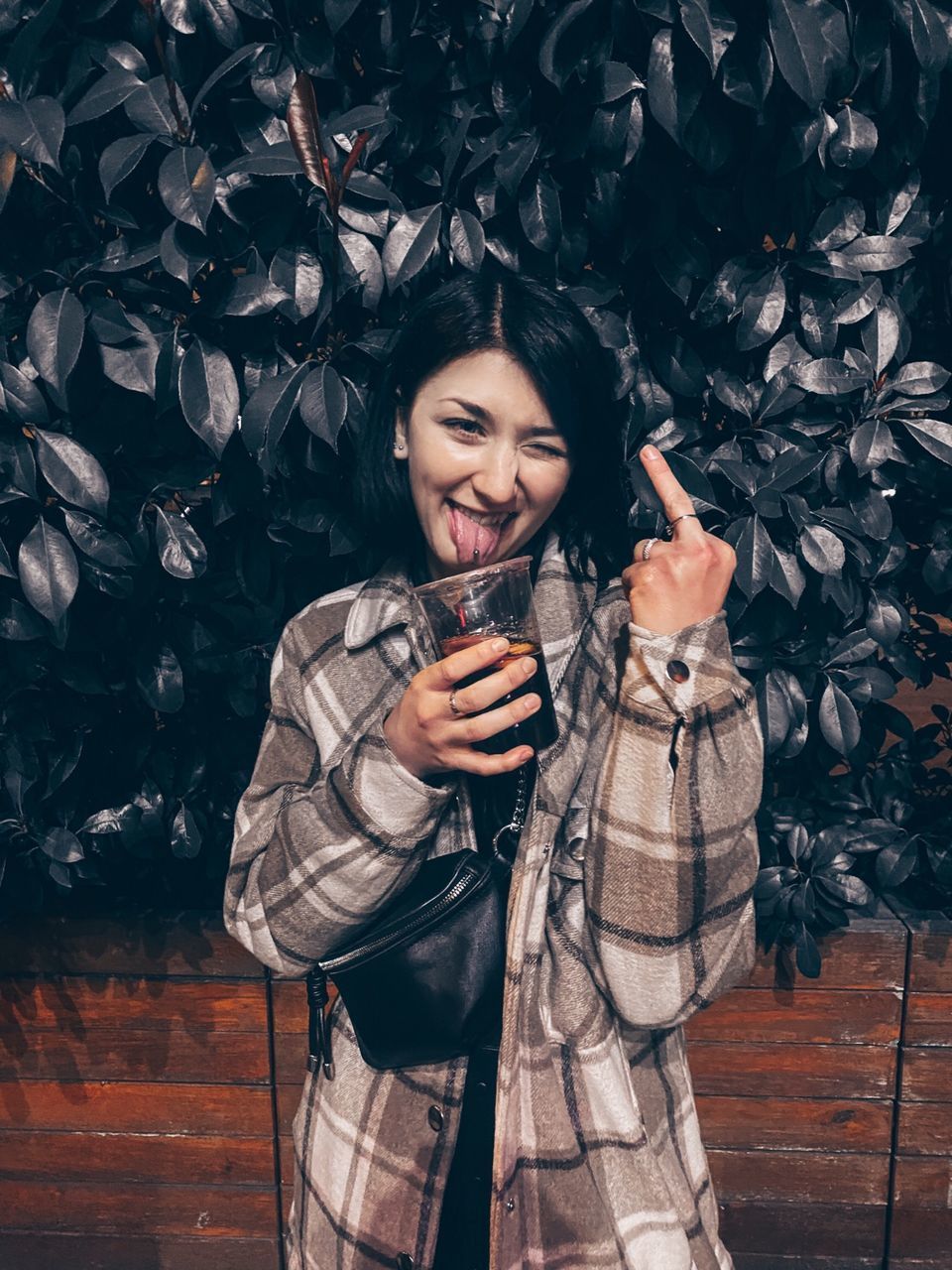 HAPPY YOUNG WOMAN LOOKING AWAY WHILE STANDING BY OUTDOORS