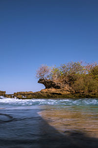 Scenic view of sea against clear blue sky