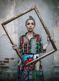 Portrait of young woman standing in factory