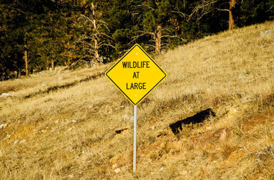 Close-up of warning sign on landscape