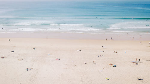 People at beach on sunny day