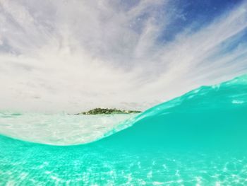 Swimming pool by sea against sky