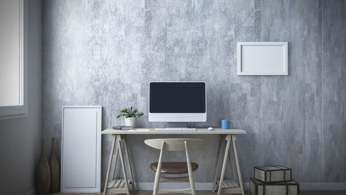 Empty chairs and table against wall at home