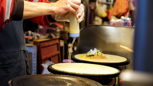 Midsection of person preparing food in night market in taiwan taipei