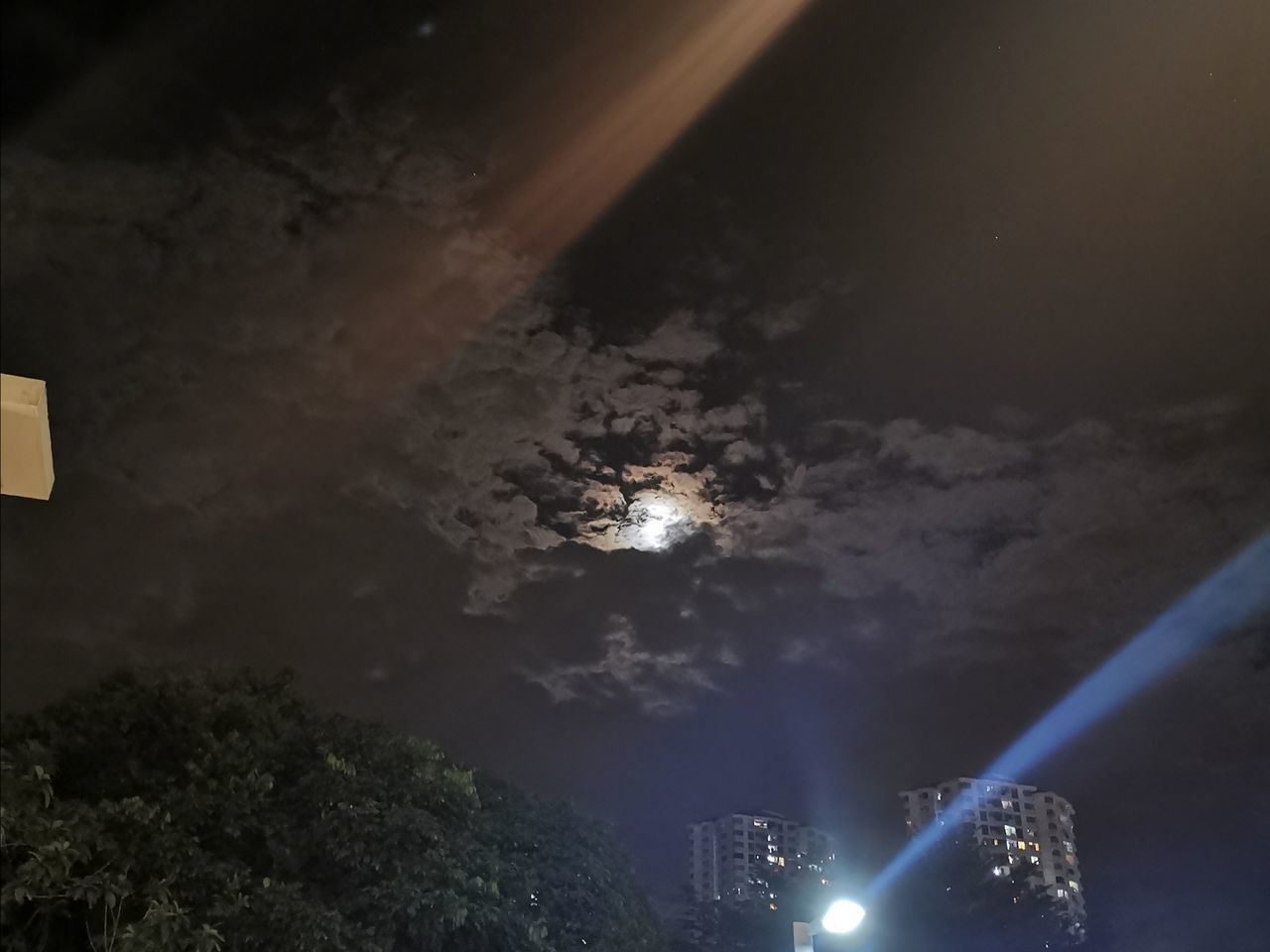 LOW ANGLE VIEW OF ILLUMINATED LIGHTS IN SKY