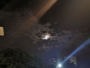 Low angle view of illuminated lights against sky at night