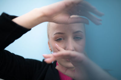 Portrait of young woman holding hands