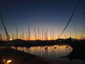 Sailboats in marina at sunset