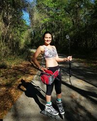 Full length of woman standing on tree trunk