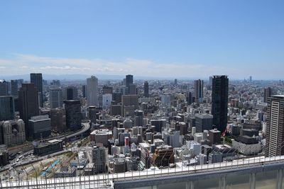 High angle view of modern buildings in city against sky