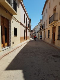 Empty alley amidst buildings in city