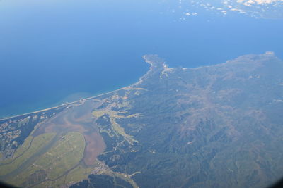 Aerial view of volcanic mountain against blue sky