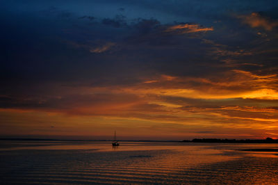 Scenic view of sea against orange sky