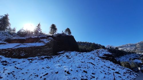 Scenic view of snowcapped mountains against clear blue sky