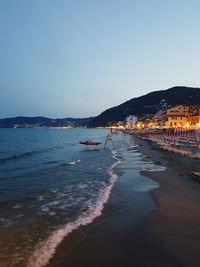 Scenic view of sea against clear sky at night