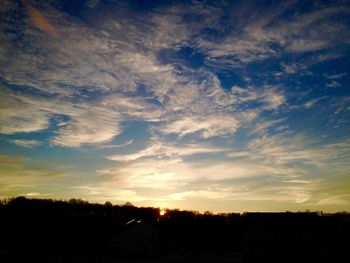 Scenic view of landscape against sky at sunset