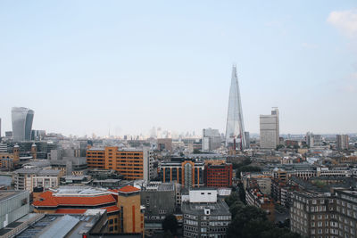 Buildings in city against clear sky