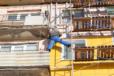Low angle view of man working at construction site