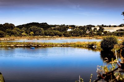 Scenic view of lake against blue sky