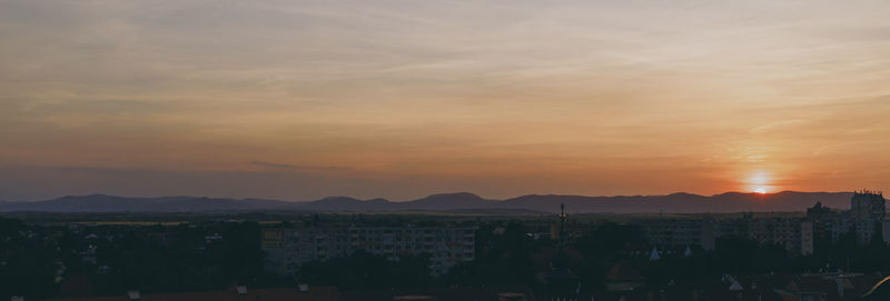 Cityscape against sky during sunset