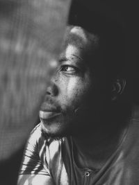 Close-up portrait of young man looking away