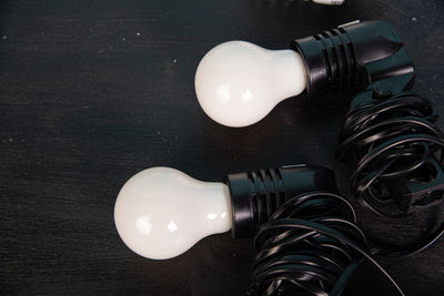 High angle view of illuminated light bulb on table