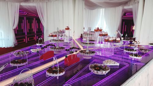 Illuminated lights on table by window in building