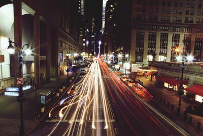 Illuminated city street at night