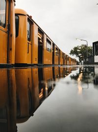 Train on railroad tracks against sky in city