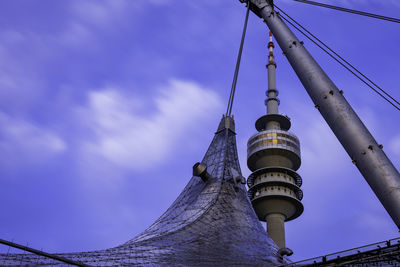 Low angle view of communications tower against sky