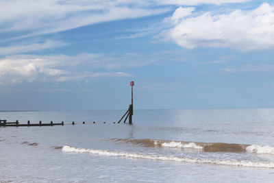 Scenic view of sea against cloudy sky