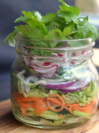 Close-up of fruits in glass jar on table