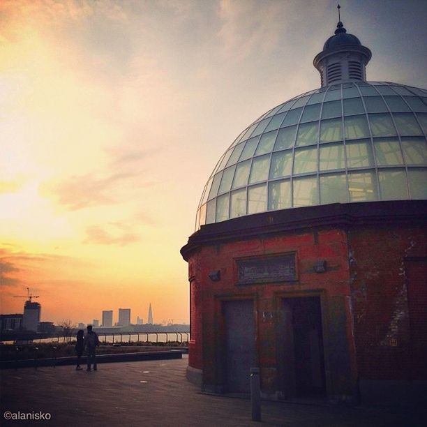 architecture, built structure, building exterior, sky, sunset, travel destinations, tower, cloud - sky, city, famous place, travel, tourism, lighthouse, international landmark, incidental people, dome, capital cities, railing, orange color