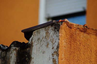 Close-up of rusty metal against wall