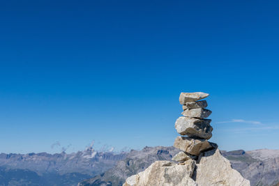 Stack of rocks against blue sky