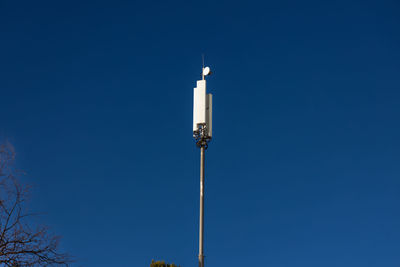Close up of antenna repeater tower on blue sky