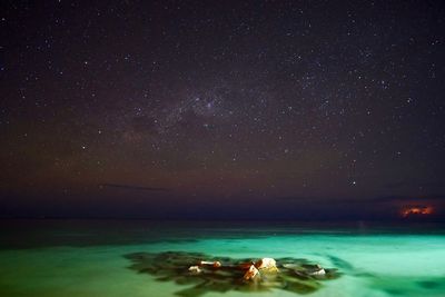 Scenic view of sea against sky at night