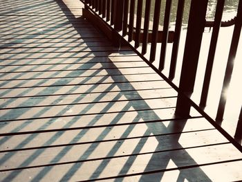 Shadow of railing on footpath
