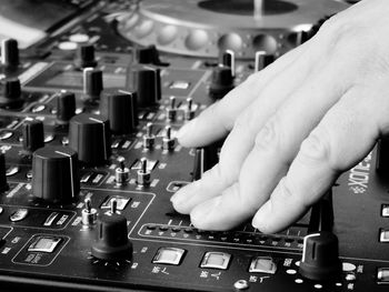 Cropped hand of dj playing sound mixer