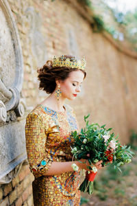 Portrait of smiling young woman holding bouquet